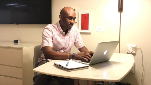 CEO Lyndon Brathwaite working on the laptop