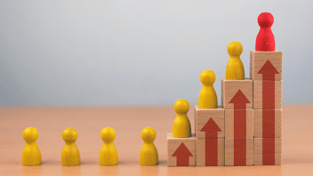 Image showing wood pieces carved like people and moving in a certain direction.