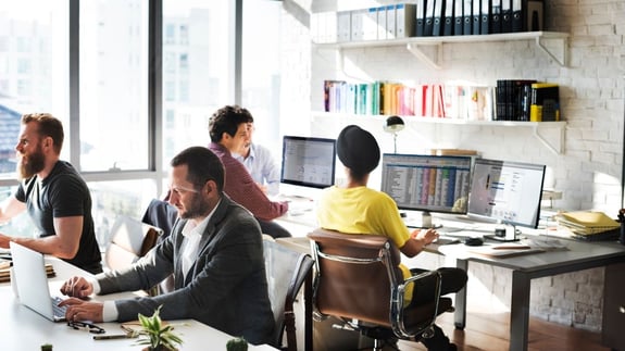 Sales Team Sitting Together In an Office