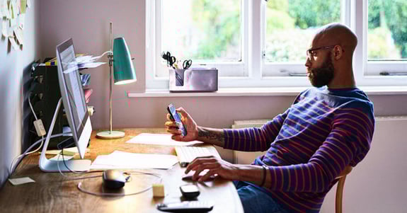 Black entrepreneur sitting at his desk working
